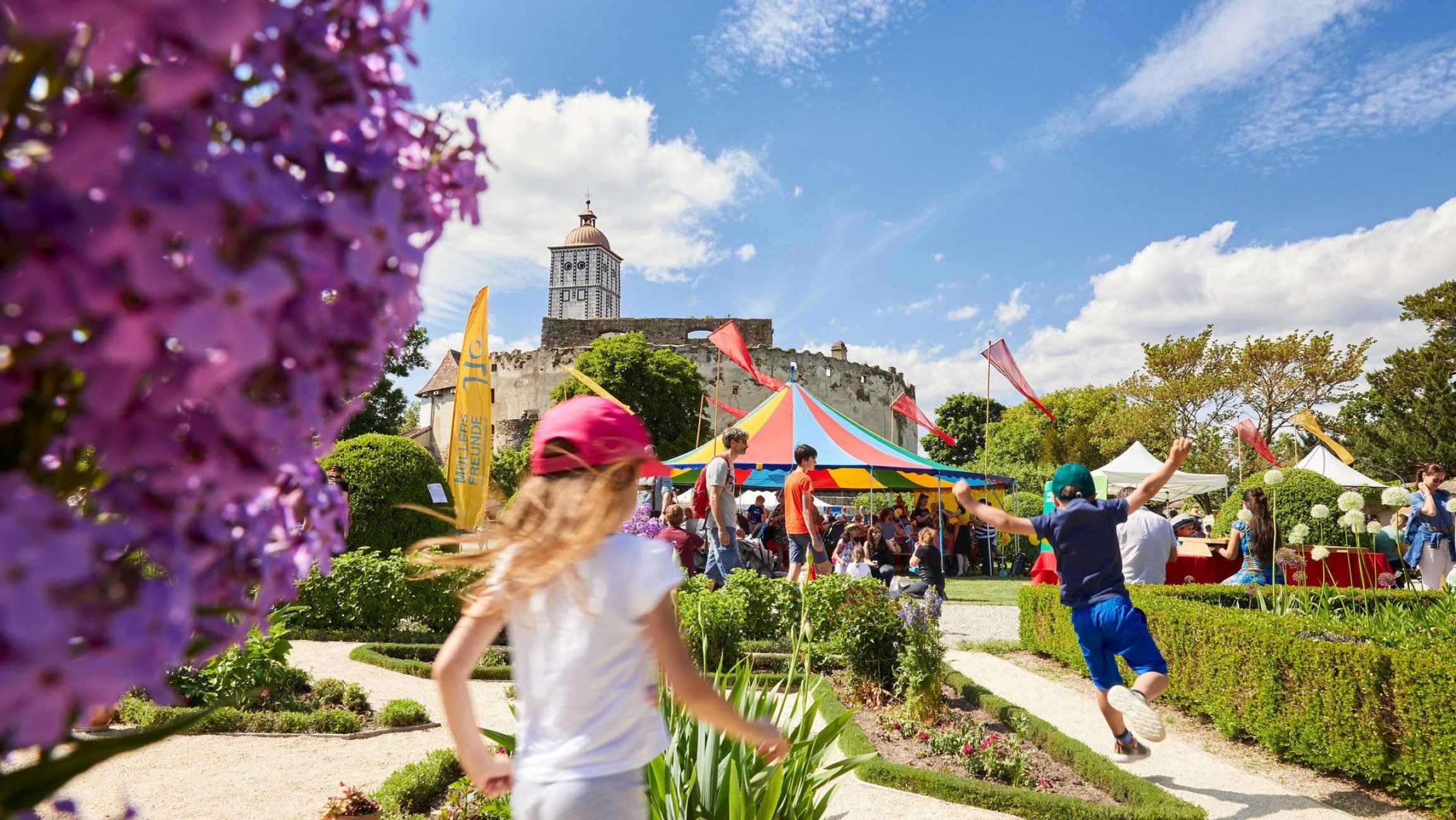 Blick auf Kinder, die in einem Garten herumlaufen.